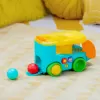 BRIGHT STARTS Autíčko vkládací s míčky Pop & Roll Safari Bus™ 6m+